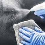 Production Employee-Strong Spas sanitizing a hot tub - image
