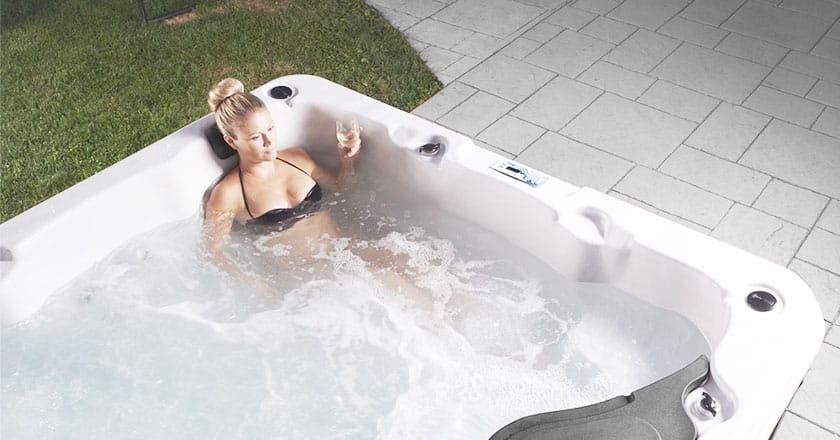 Top 5 Questions to Ask Before Buying a Hot Tub-Women with a glass of white wine in Strong Spas hot tub